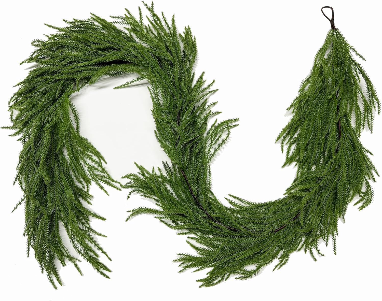 Green artificial Norfolk pine garland arranged in a curved shape on a white background.